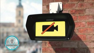 Kamera an Ziegelwand, im Display ein schwarzes, durchgestrichenes Kamerasymbol auf gelben Hintergrund